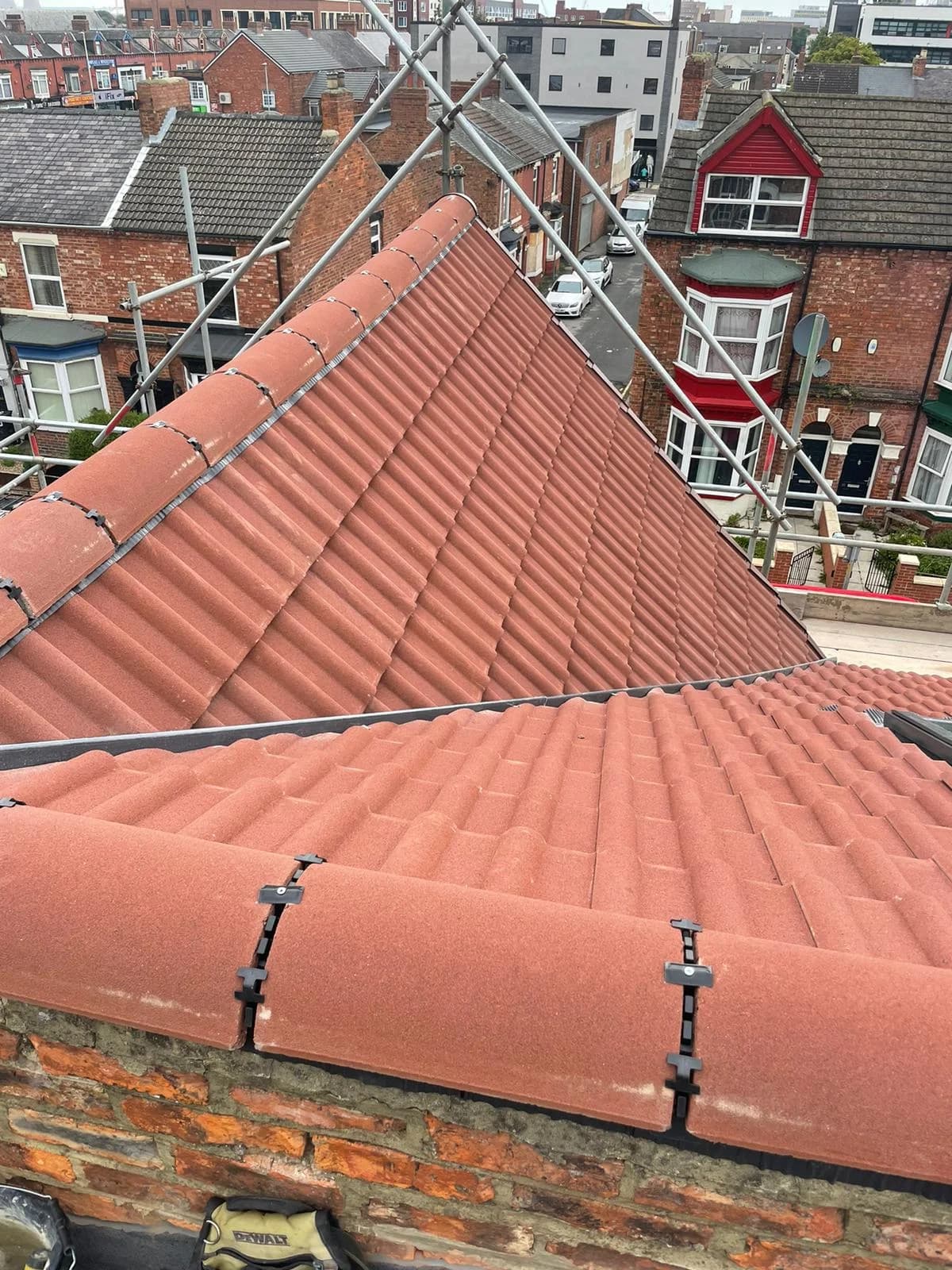 A repaired tiled hip roof on a terrace